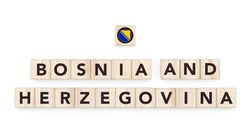 Wooden blocks bearing the name and flag of Bosnia And Herzegovina. Bosnian and European Culture, national identity, travel, and geography in a copy space design.