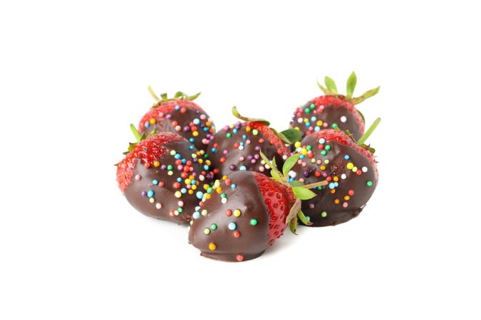 Chocolate fondue. Strawberry in chocolate isolated on plain background