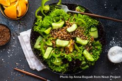 Top view of green fresh salad with buckwheat on concrete background served with flax seed and lemon 4Az3Lq