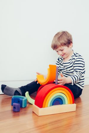 Boy playing with wooden construction pieces