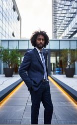 Confident businessman standing on downtown street