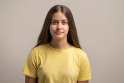 Neutral expression front view headshot of a young woman.