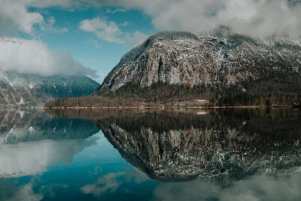Perfect turquoise lake reflecting cloudy sky
