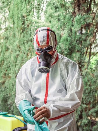 Man in suit for fumigation in yard