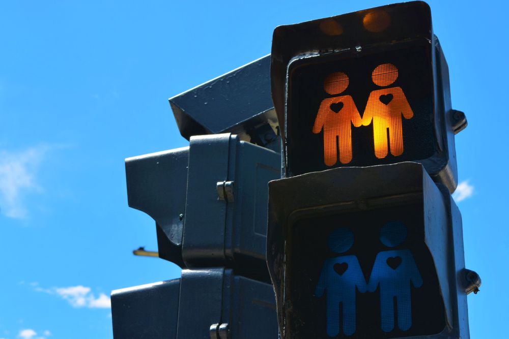 Close up of street light with two people holding hands