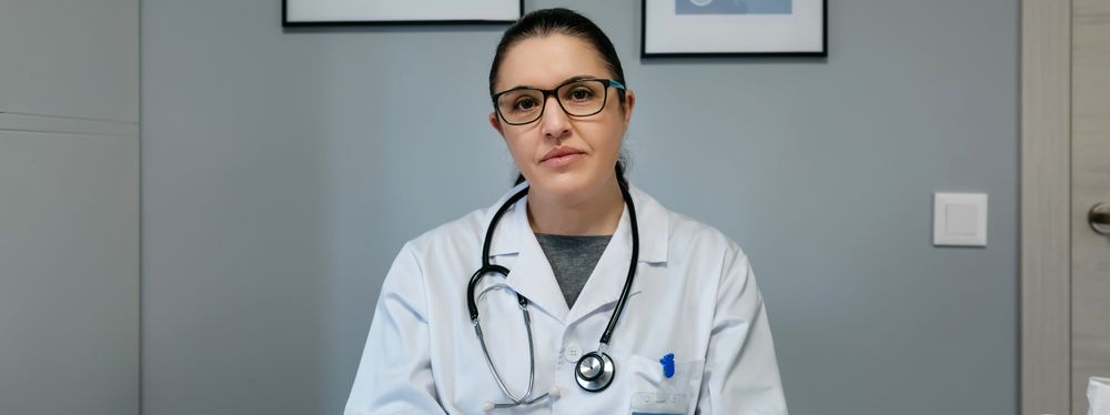 Female doctor looking at camera in her office