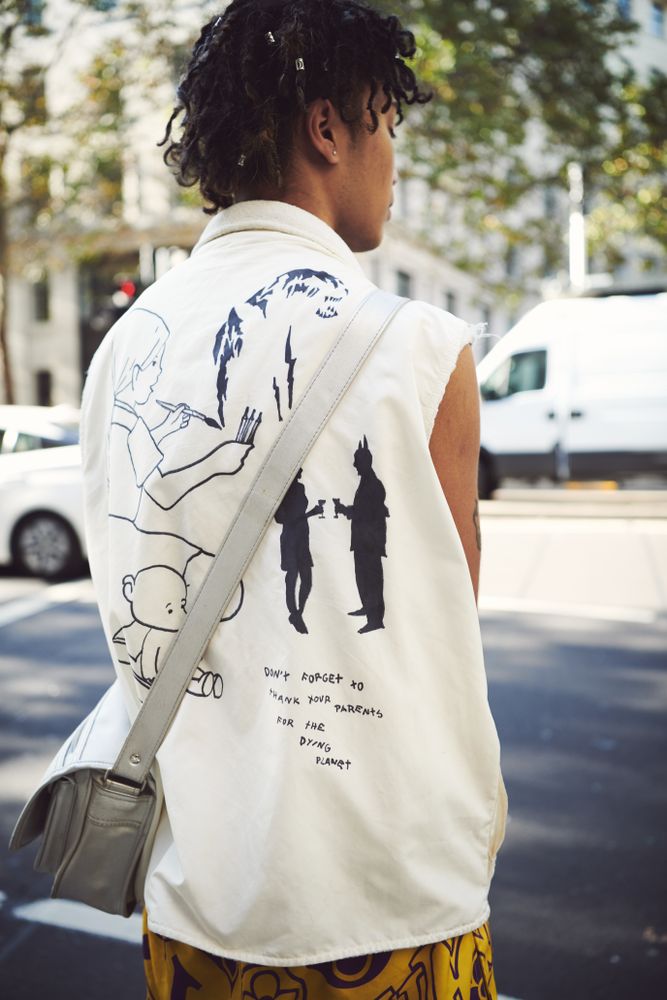 London, England, United Kingdom - September 15th, 2019: Rear shot of young woman in bold vest