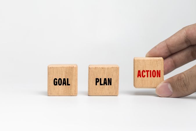 male hand put goal, plan, action words text on wooden blocks