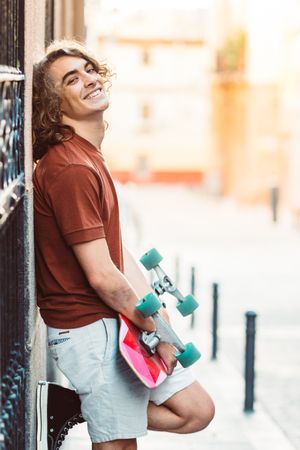 Man carrying longboard on the street