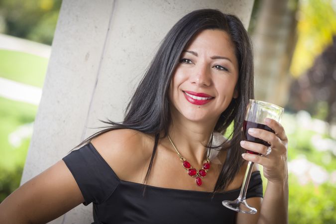 Hispanic Woman Portrait Outside Enjoying Wine