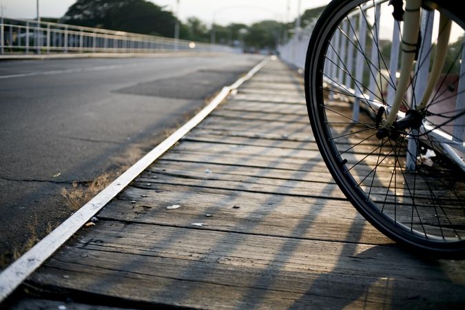 Wheel of a bike on an empty bridge