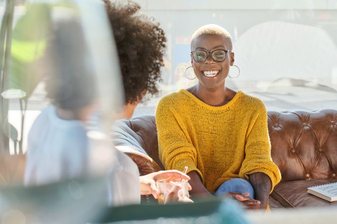 Cheerful Black woman with friend at home