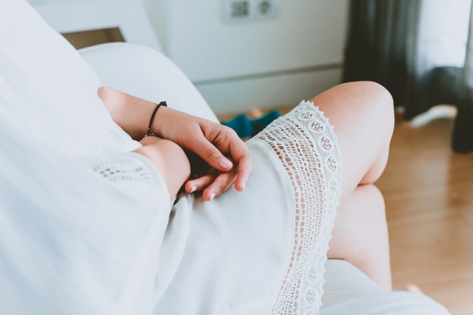 Woman in dress sitting in room