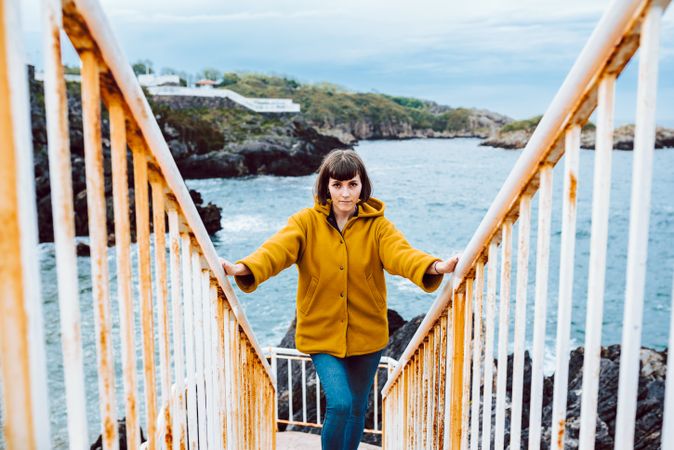 Woman standing on steps near sea
