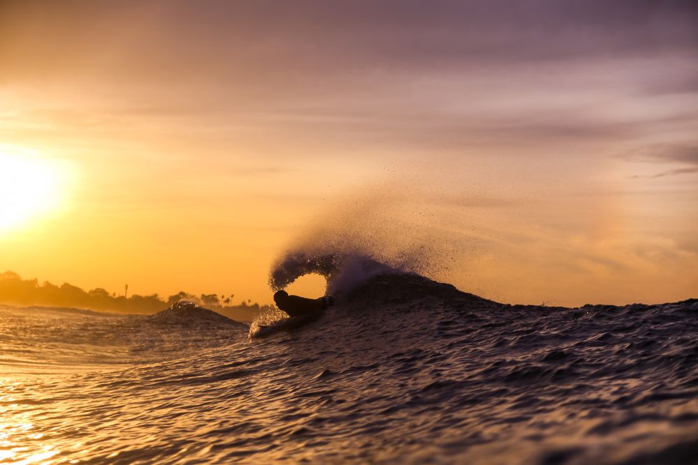 Man on surf board floating on wavy water