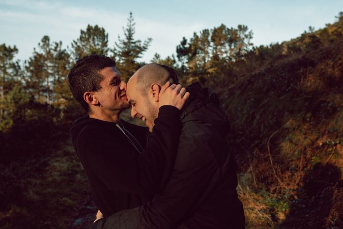 laughing men hugging in countryside road