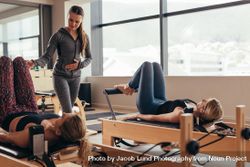 Two fitness women training at a pilates gym 5qzG14