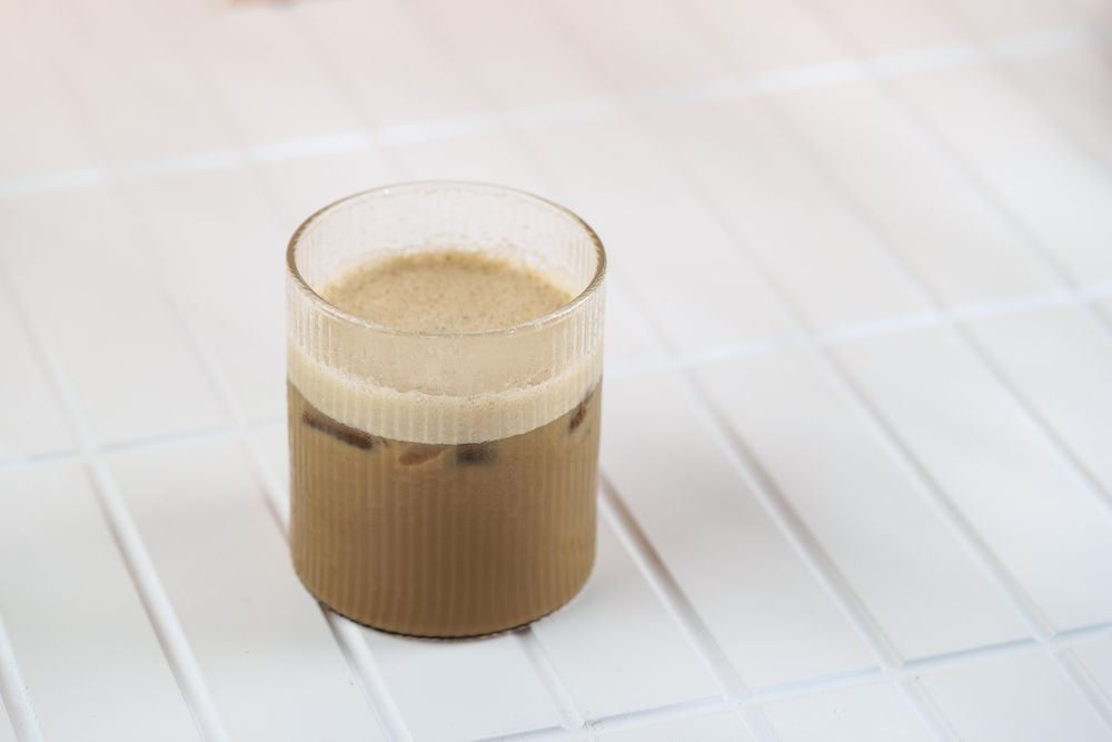 Iced coffee with milk on tiles