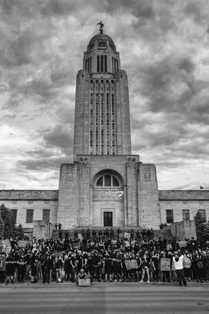 Grayscale photo of people in front of Nebraska State Capitol