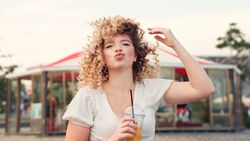 Woman with drink outdoors