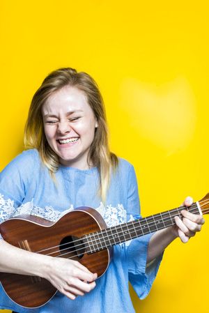 Woman enjoying playing ukulele