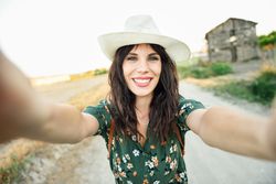 Happy brunette female taking a selfie