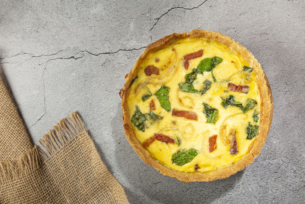 Spinach quiche with onion and bacon.