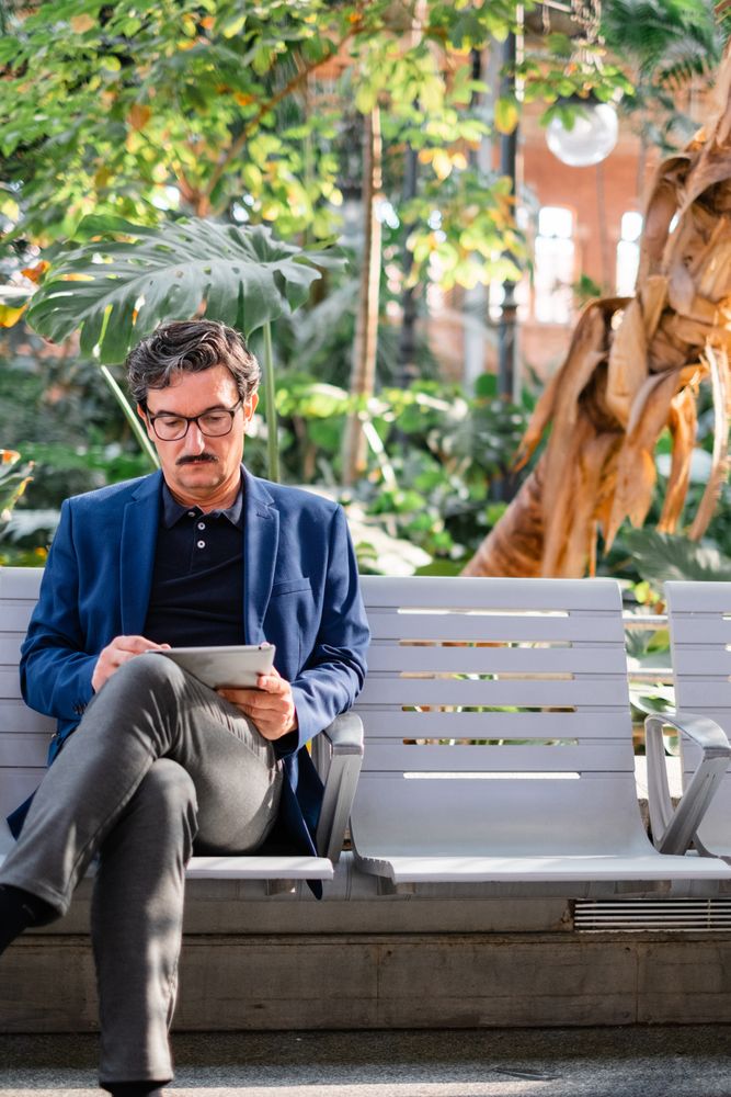 handsome man using digital tablet outdoors