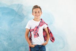 Boy in t-shirt, jeans and shirt against color background, space for text