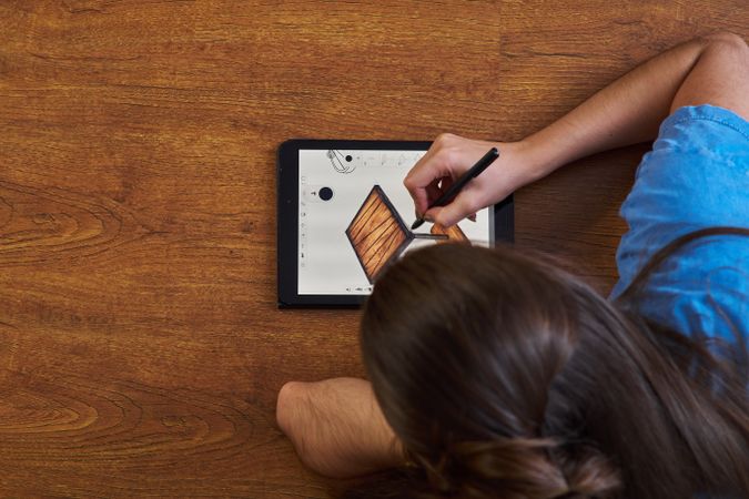 Woman drawing table on tablet