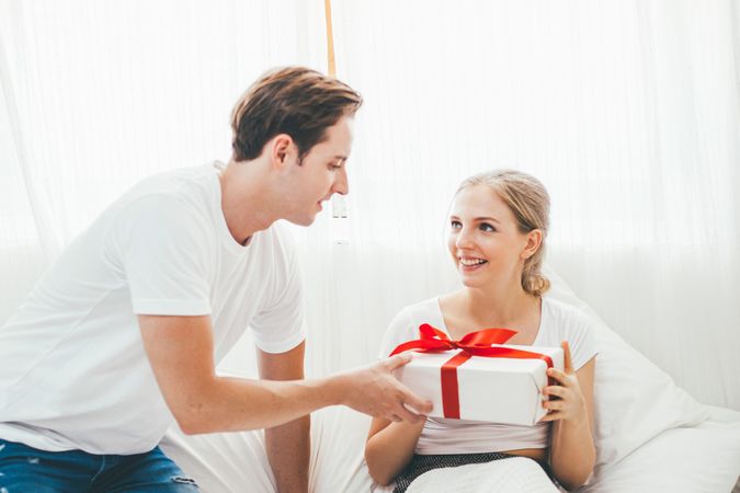 Young man giving a present to his girlfriend on Valentine's Day