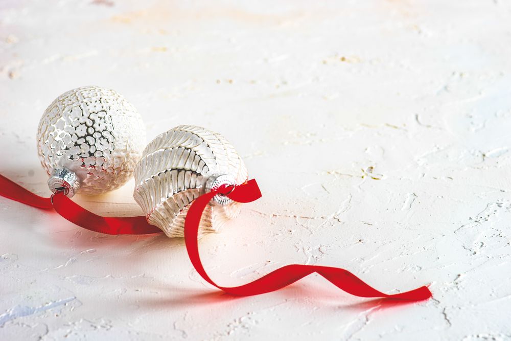 Snowy decor of baubles and red ribbon