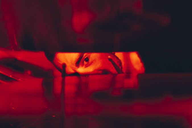 Man with drumsticks in redness