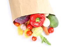 Paper bag with different vegetables isolated on plain background