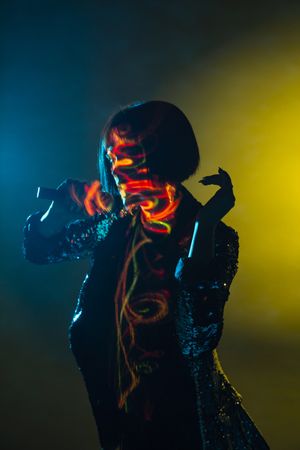 Stylish woman singing on stage