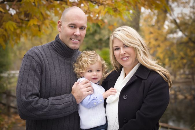 Happy Parents and Child Portrait in Park