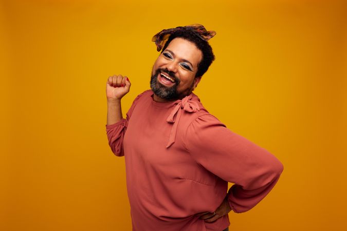 Gender fluid male posing on yellow background