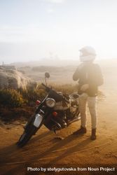 Motorcyclist on dusty road 0VRjr0