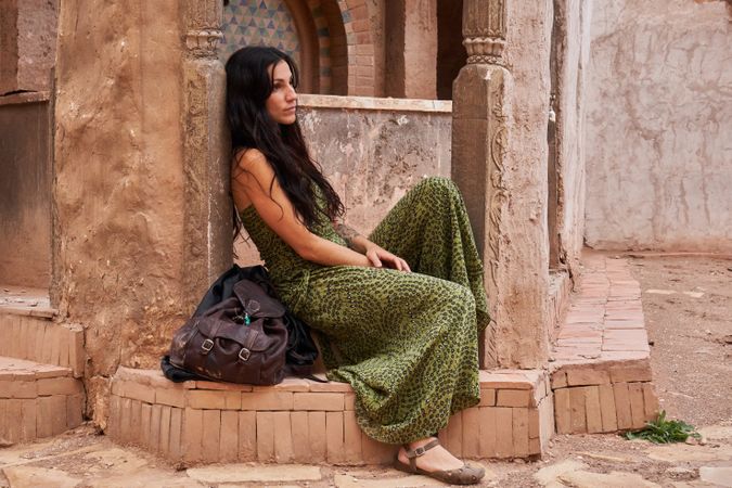 Woman on street between ancient buildings