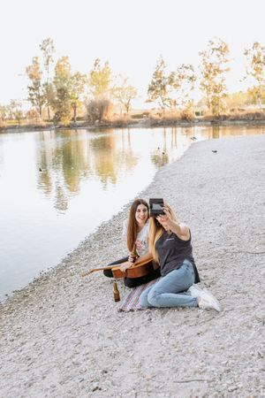Girl friends taking selfie on beach