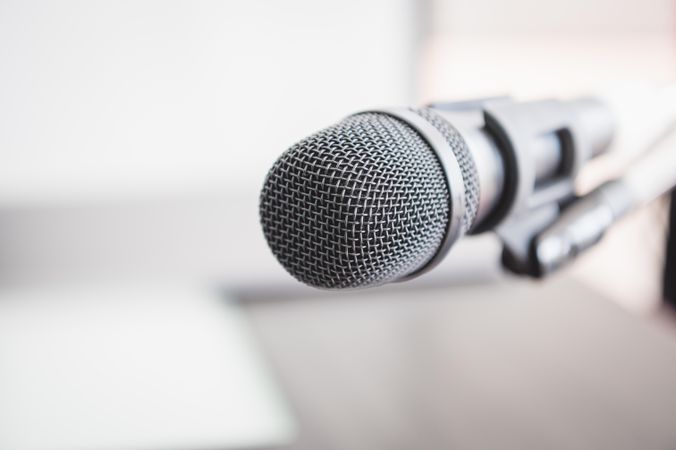 Closeup of microphone in lecture room background speech in seminar convention hall room