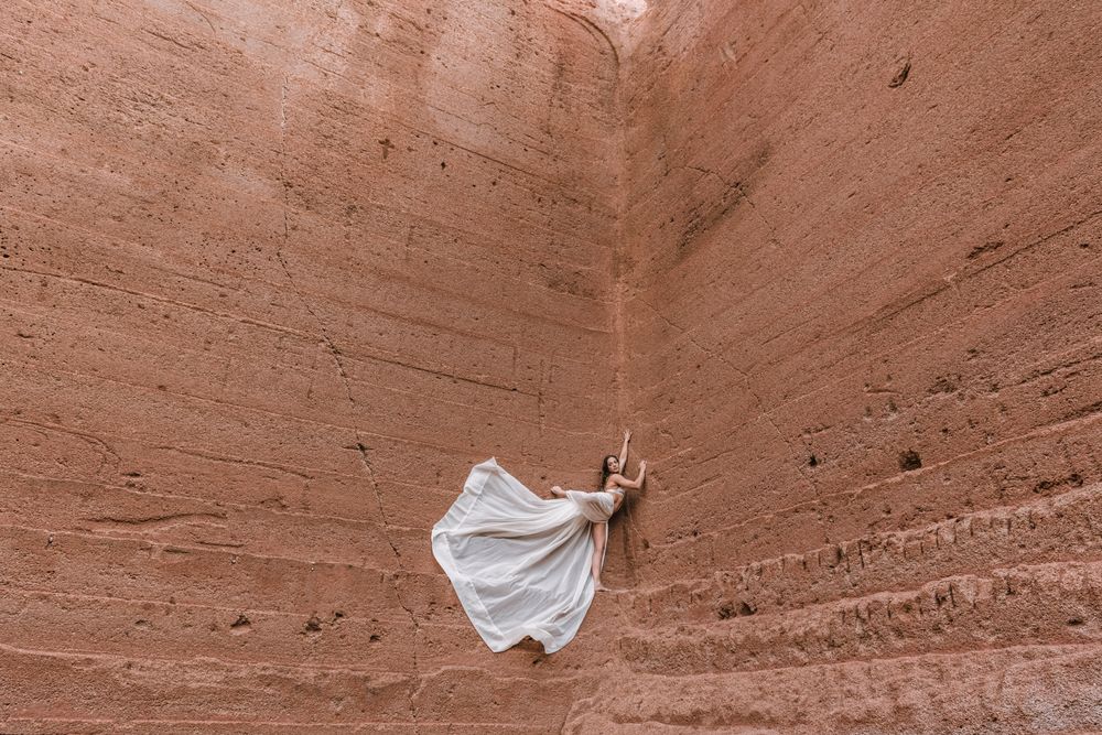 Elegant female posing on rocky cliff
