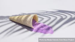 Ice cream cone with purple sand under palm tree shadow 4BerW5
