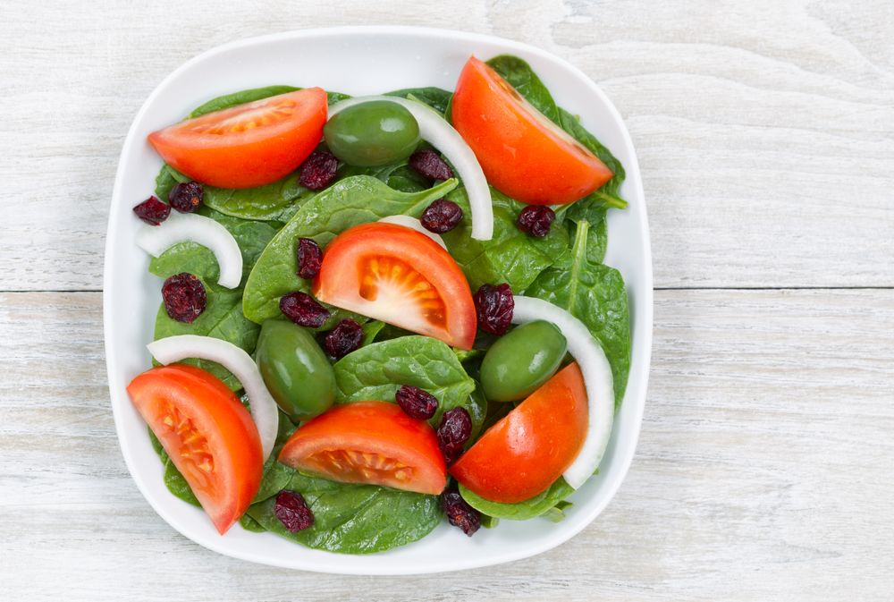 Close up Top View of Fresh Salad in plate on wood