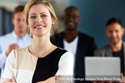 Close up of smiling businesswoman in front of her colleagues 5oymkb