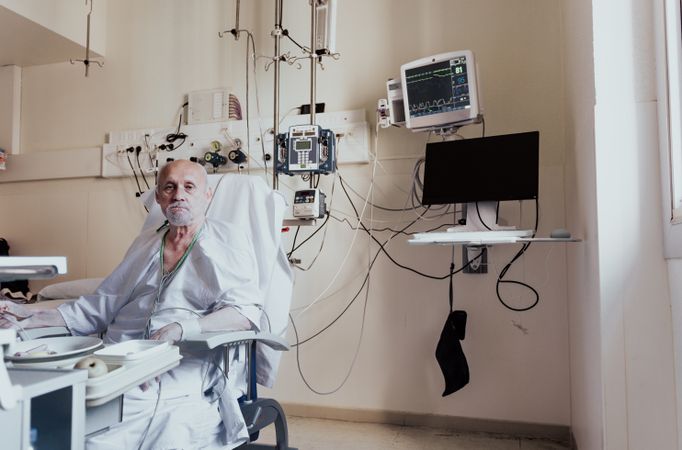 Older man admitted to a hospital room.