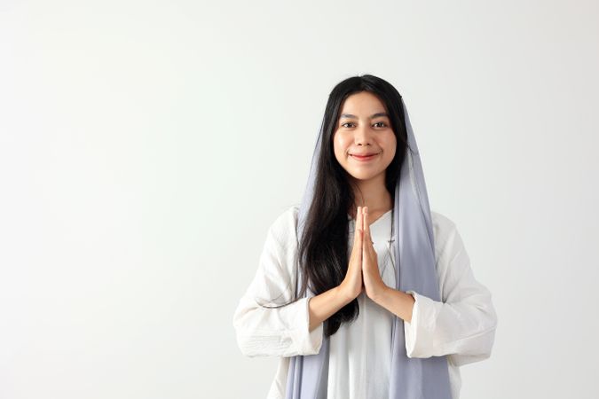 Young Indonesian Muslim Woman Wearing Hijab Scarf Gesturing Eid Mubarak Greeting