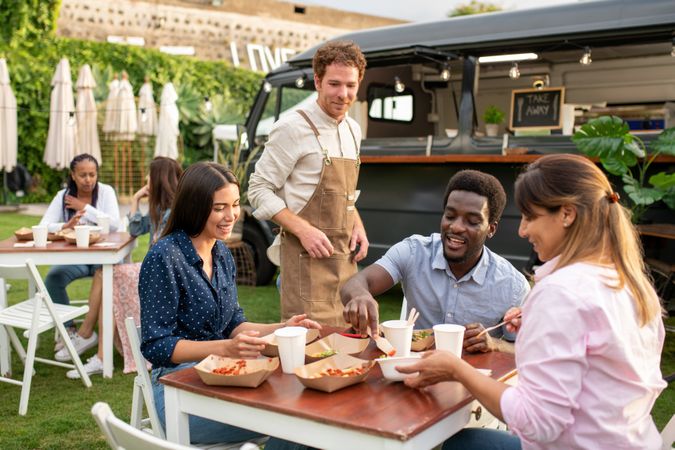 Group of diverse friends having picnic