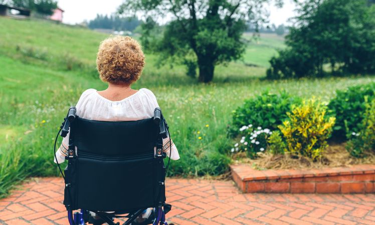 Unrecognizable mature woman in a wheelchair