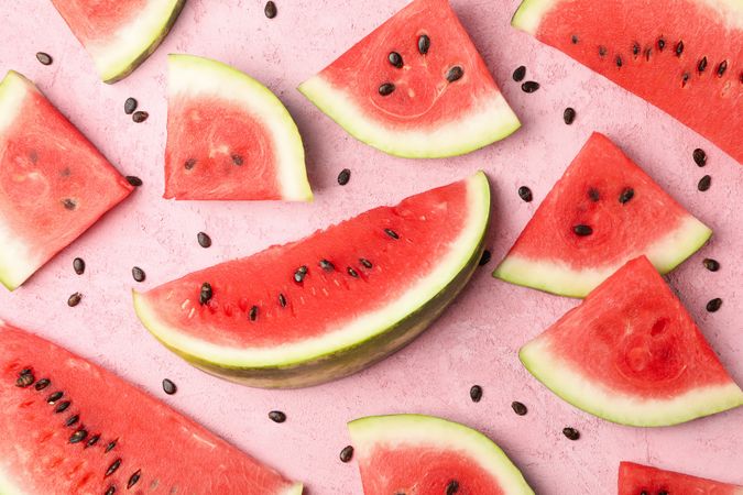 Composition with watermelon slices on pink background, top view